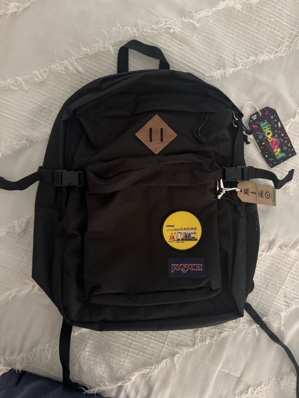 Jansport Black Backpack with Brown Patch and Yellow Pin